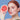 Smiling woman touching face with green leaves on the side, on a blue background.